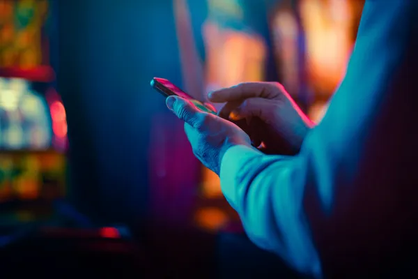 ZBZBET — A high-class gaming experience without limits A woman in a luxurious green gown next to an ornate roulette wheel, capturing the upscale casino mood of ZBZBET.